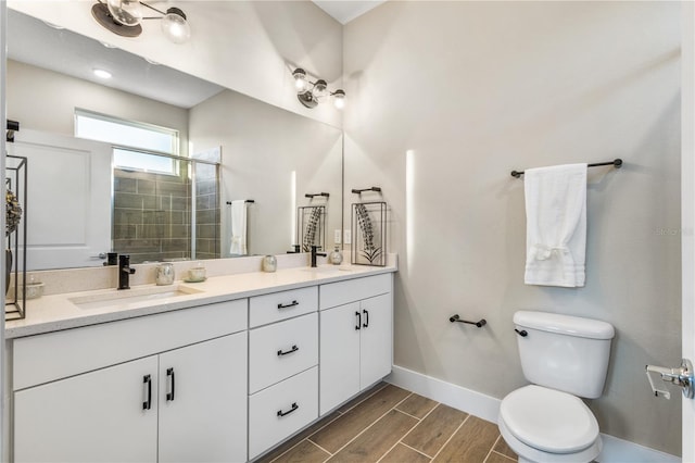 1800 Houston St, Kissimmee, FL 34743 - bathroom featuring double vanity, a tile shower, and wood finish floors