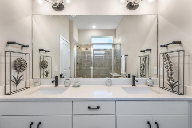 bathroom with vanity and a shower with door