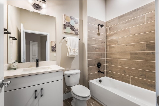 full bathroom featuring vanity, toilet, and tiled shower / bath