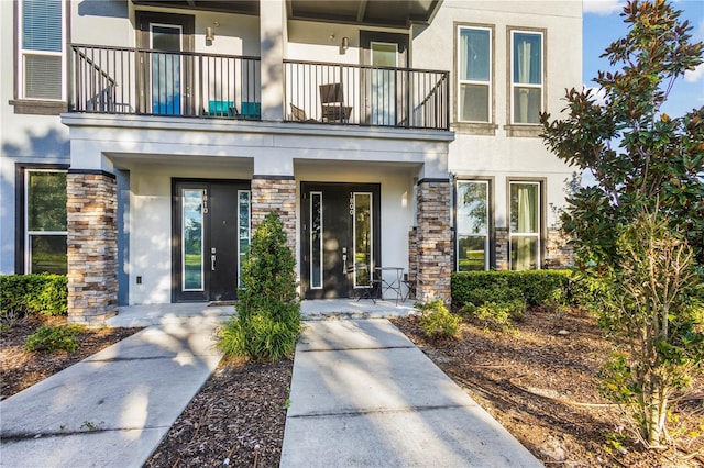 1800 Houston St, Kissimmee, FL 34743 - entrance to property with stucco siding, a balcony, and stone siding