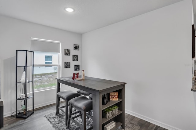 dining space with dark wood-type flooring