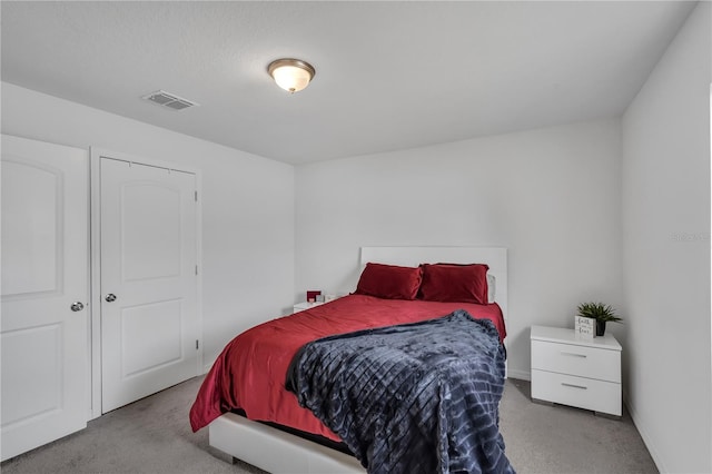 carpeted bedroom featuring a closet