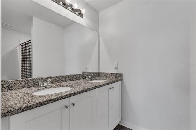 bathroom with vanity and curtained shower