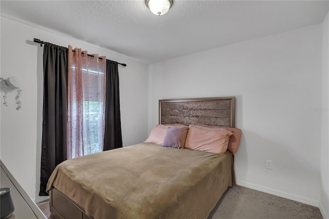 carpeted bedroom featuring a textured ceiling