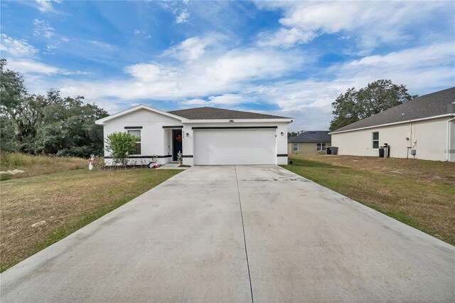 view of front of property featuring a garage and a front yard