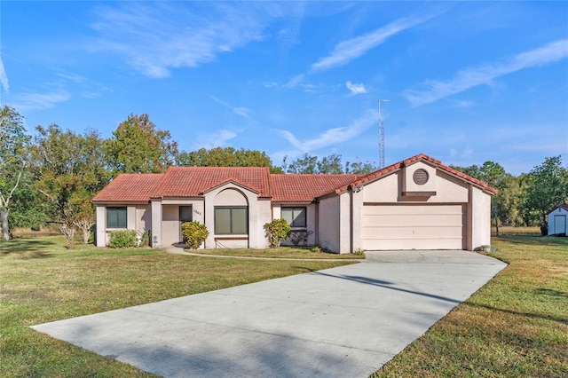 mediterranean / spanish-style house with a garage and a front lawn