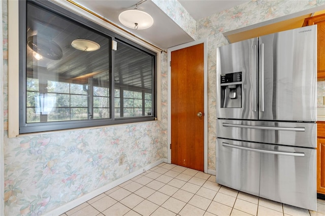 kitchen with stainless steel fridge and light tile patterned flooring