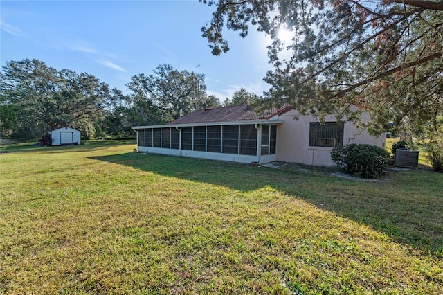 view of yard featuring a sunroom and a shed