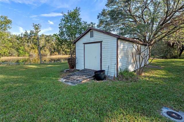 view of outbuilding featuring a lawn