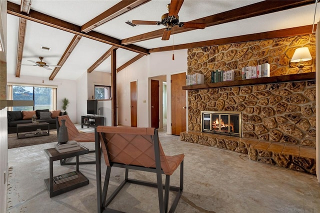 living room with lofted ceiling with beams, a stone fireplace, and ceiling fan