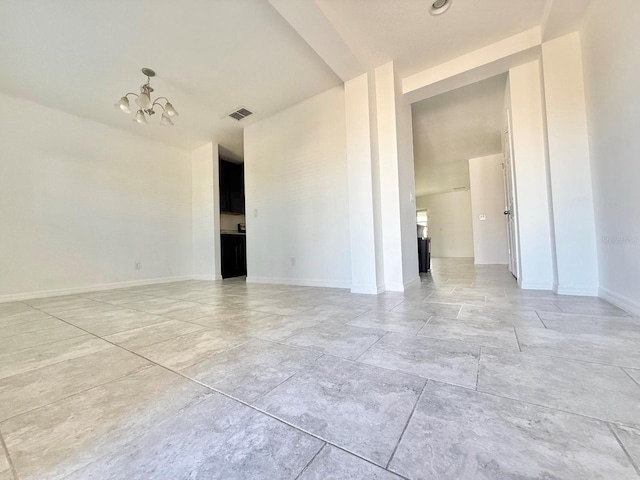 unfurnished room featuring an inviting chandelier