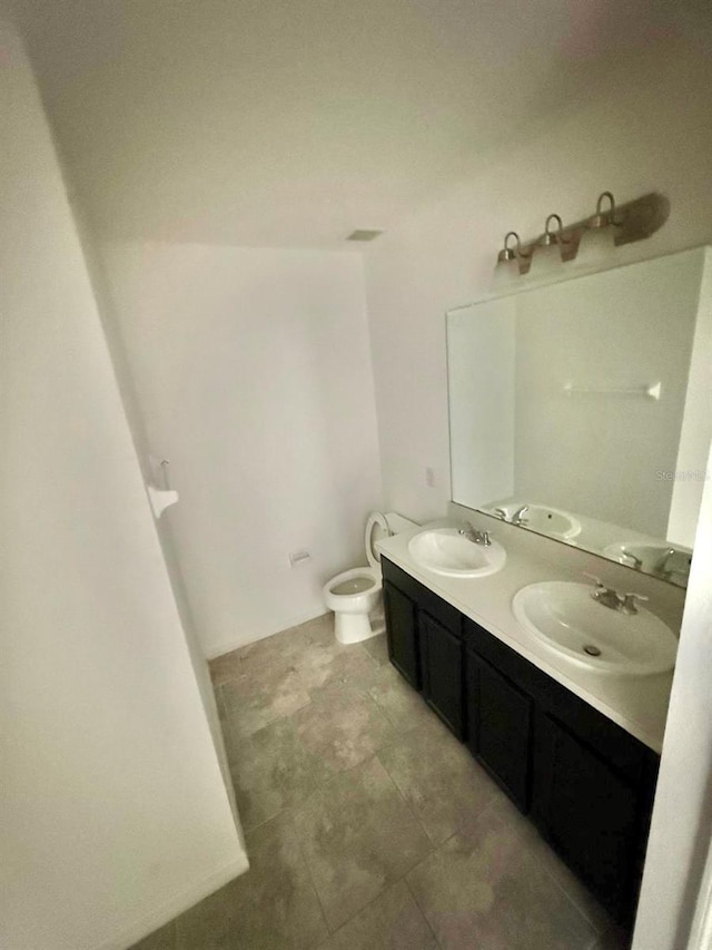 bathroom featuring vanity and toilet