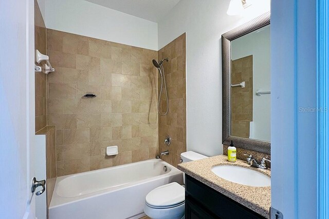 bathroom featuring vanity, toilet, and shower / bathtub combination