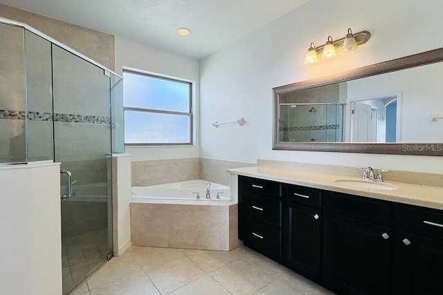 full bath with tile patterned flooring, a stall shower, vanity, and a garden tub