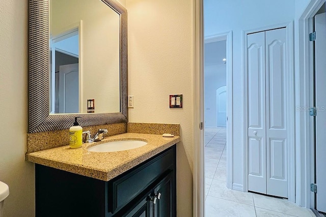 bathroom with tile patterned flooring and vanity