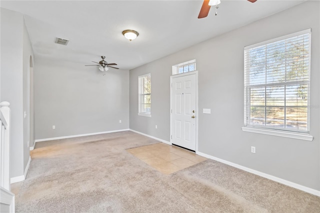 carpeted foyer featuring ceiling fan