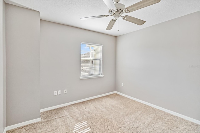 carpeted empty room featuring ceiling fan and a textured ceiling