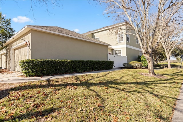 view of side of property with a lawn