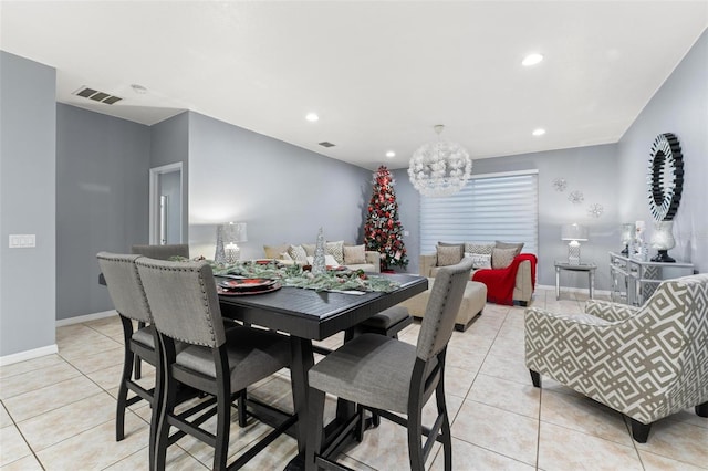 dining area featuring light tile patterned flooring and a chandelier