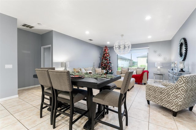 tiled dining area with a notable chandelier