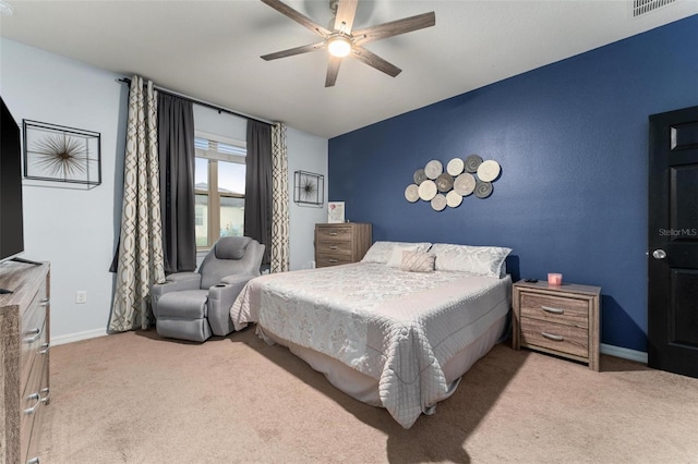 bedroom with ceiling fan and light carpet