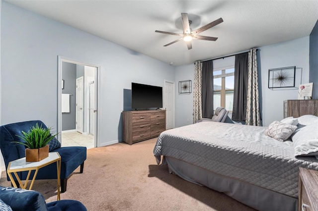 bedroom featuring connected bathroom, ceiling fan, and light carpet