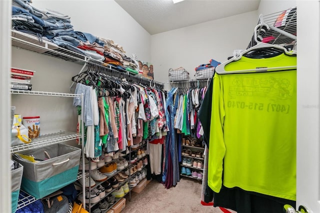 walk in closet featuring carpet