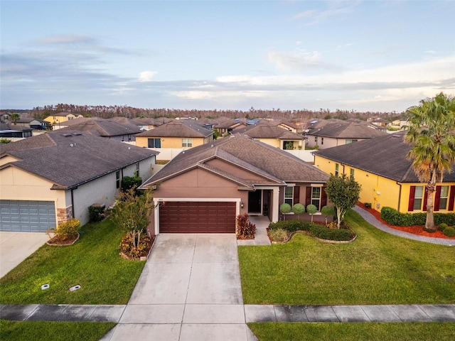 ranch-style house featuring a garage and a front lawn