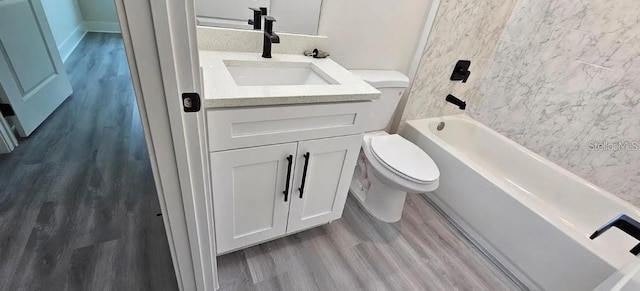 full bathroom featuring vanity, toilet, wood-type flooring, and washtub / shower combination