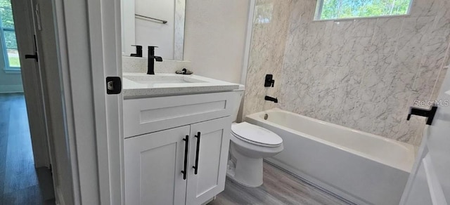 full bathroom featuring wood-type flooring, vanity, toilet, and a wealth of natural light