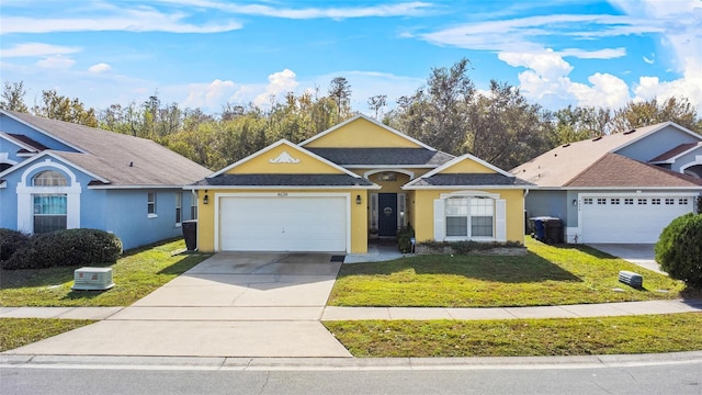 ranch-style house featuring a garage and a front lawn