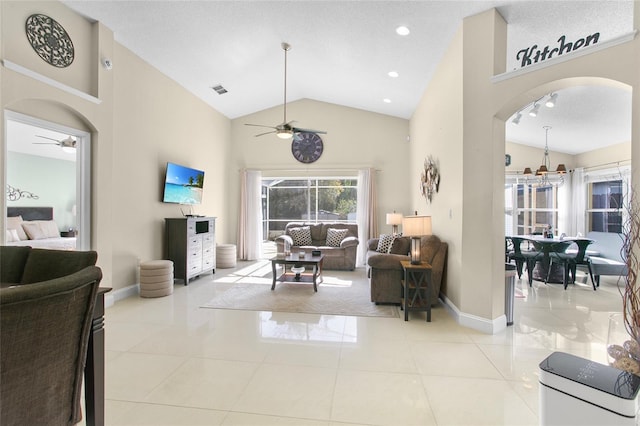 tiled living room featuring a textured ceiling, high vaulted ceiling, and ceiling fan