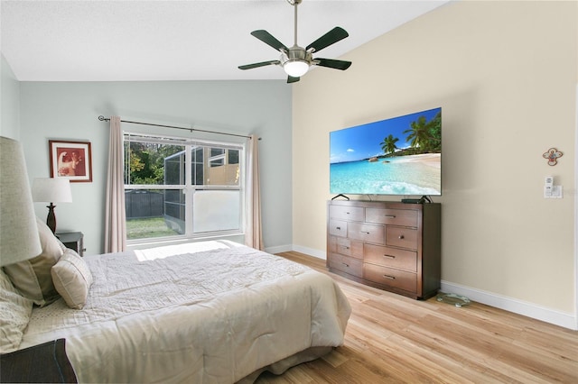 bedroom featuring ceiling fan, light hardwood / wood-style floors, and vaulted ceiling