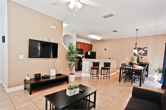 tiled living room with ceiling fan