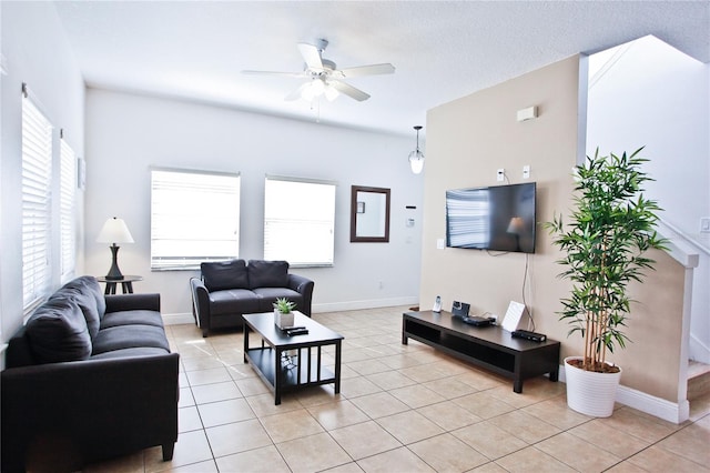 tiled living room with a textured ceiling and ceiling fan