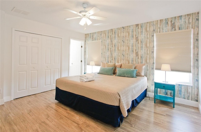 bedroom featuring hardwood / wood-style floors, a closet, and ceiling fan