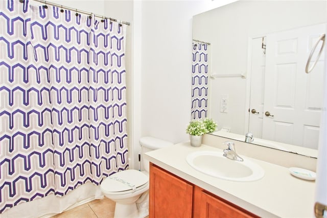 bathroom with tile patterned floors, a shower with curtain, toilet, and vanity