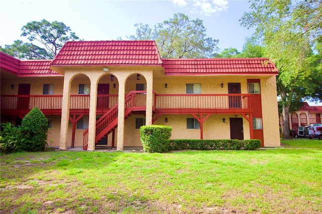 back of property featuring a lawn