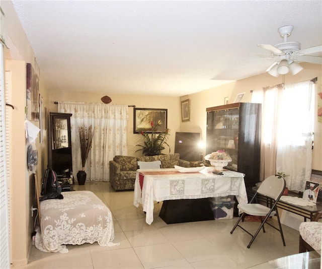 bedroom with ceiling fan and light tile patterned flooring