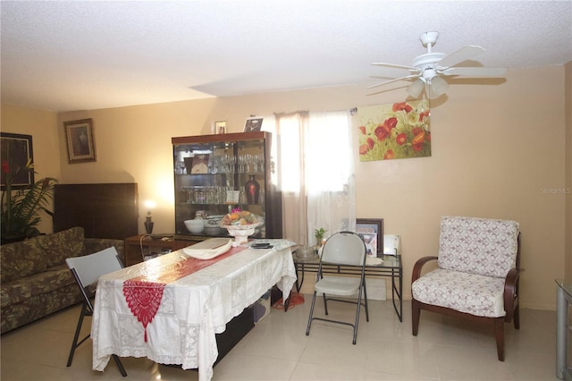 dining area with a textured ceiling and ceiling fan