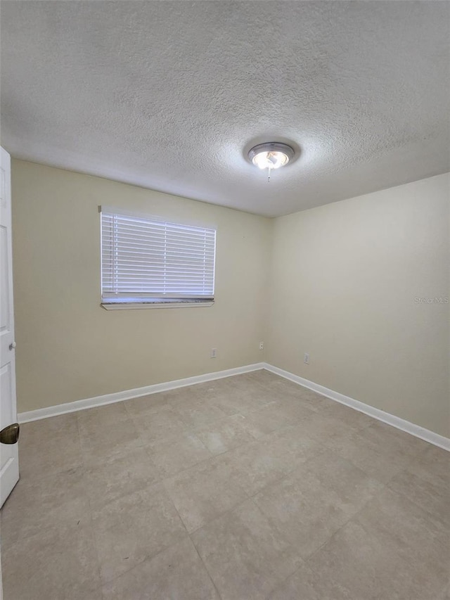 empty room with a textured ceiling