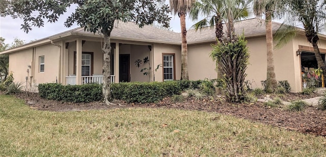 ranch-style home featuring a front yard and a porch