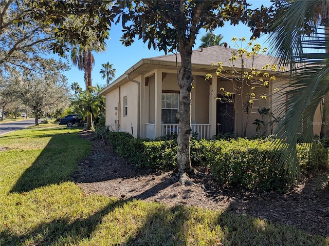 view of side of property featuring a yard