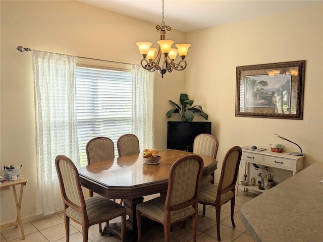 tiled dining room with a notable chandelier