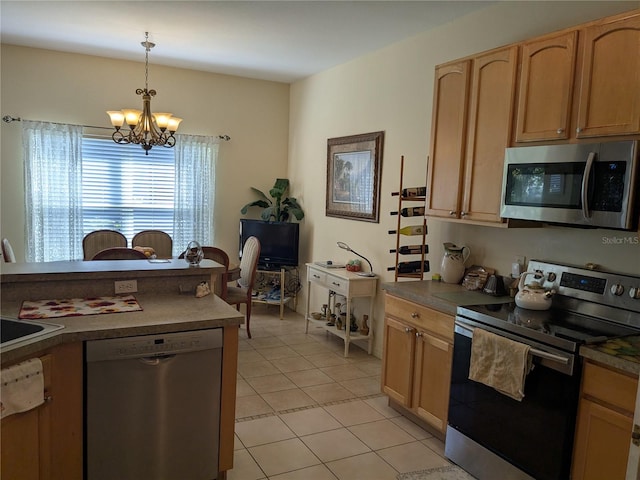 kitchen featuring light tile patterned flooring, hanging light fixtures, stainless steel appliances, light brown cabinetry, and a chandelier