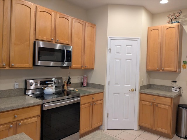 kitchen featuring light tile patterned floors and stainless steel appliances