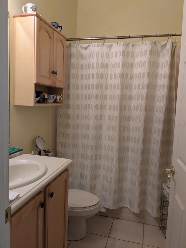 full bathroom featuring shower / bath combo, tile patterned floors, vanity, and toilet