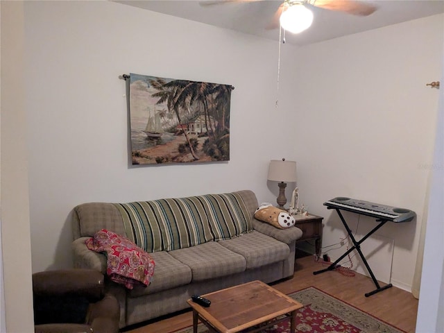 living room with ceiling fan and light hardwood / wood-style flooring