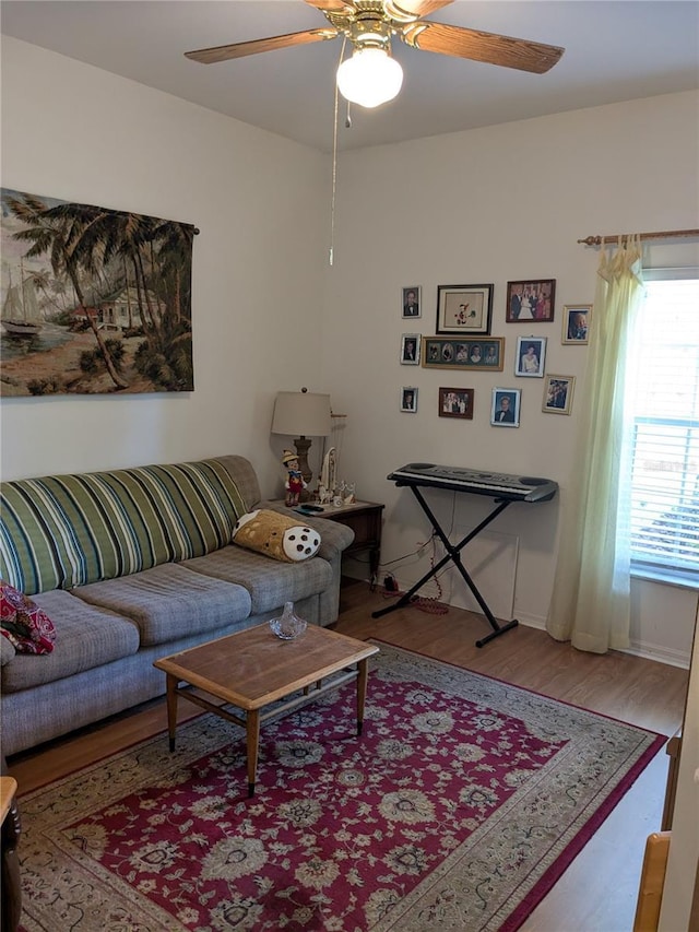 living room featuring ceiling fan and hardwood / wood-style floors