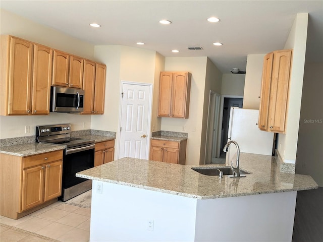 753 Largo Pass, Poinciana, FL 34759 - kitchen featuring visible vents, a peninsula, light stone counters, a sink, and stainless steel appliances